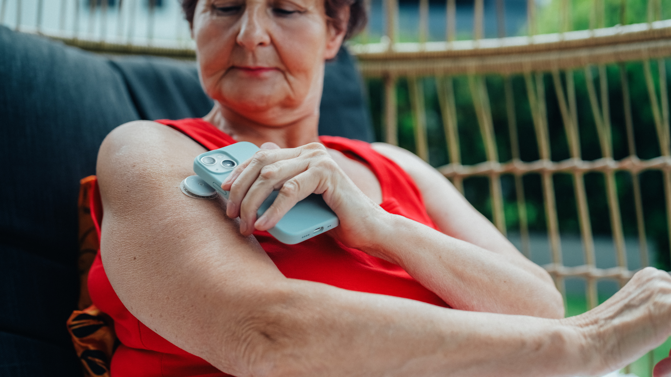 Senior woman with type 1 diabetes monitoring blood sugar with phone